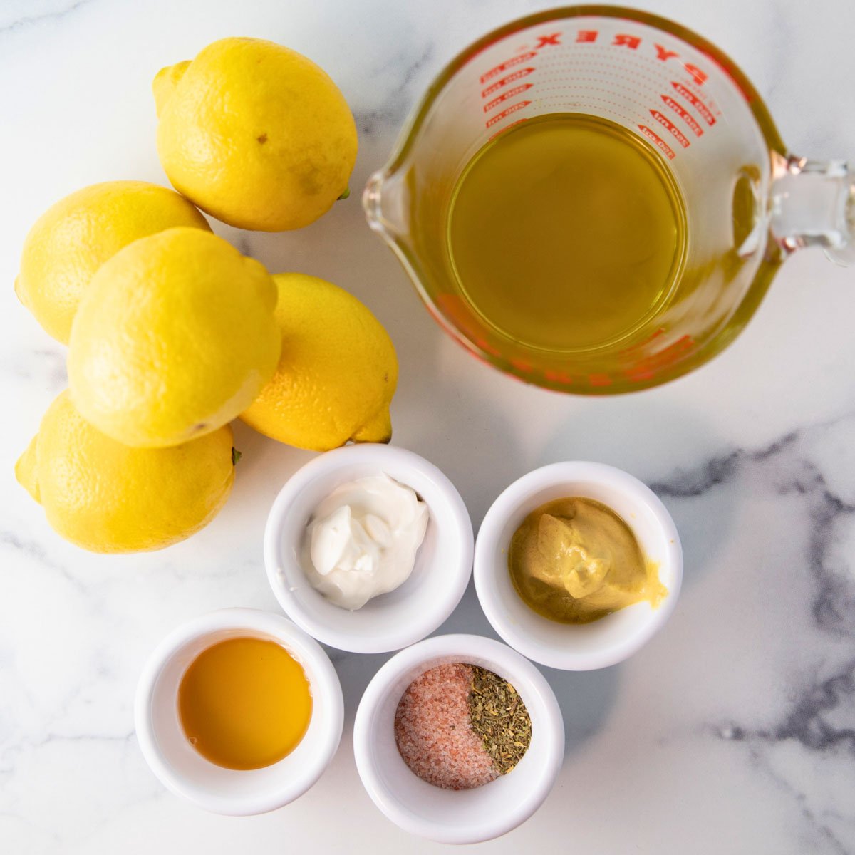 overhead of lemon vinaigrette dressing ingredients